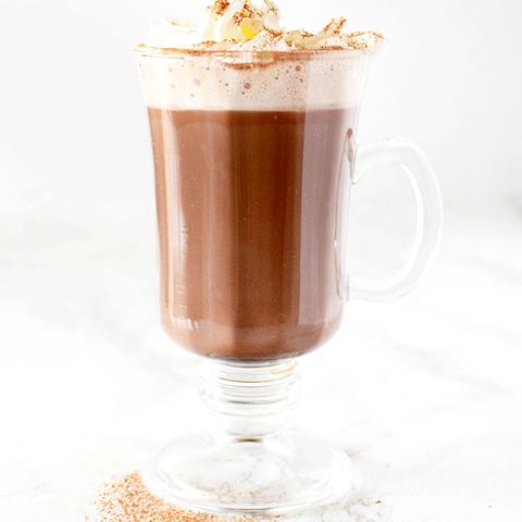 Dairy free hot chocolate with whipped cream and cinnamon