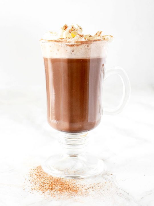 Dairy free hot chocolate with whipped cream and cinnamon
