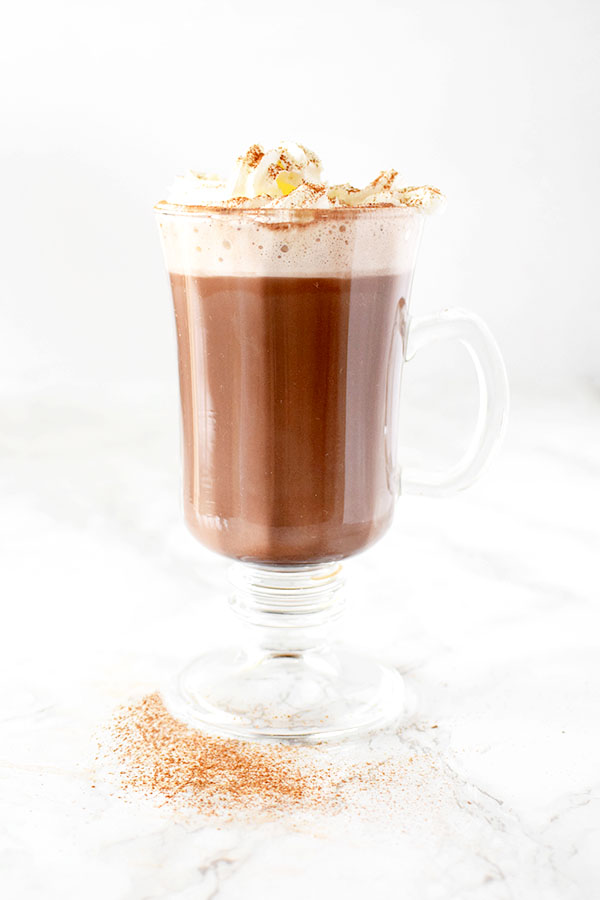 Hot chocolate with oat milk whipped cream and cinnamon