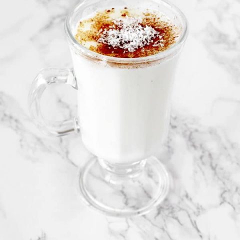 Cup of sachlav topped with cinnamon and coconut