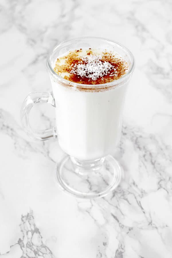 Cup of sachlav topped with cinnamon and coconut