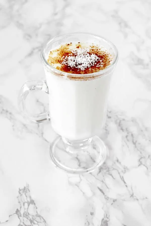 Cup of sachlav topped with cinnamon and coconut