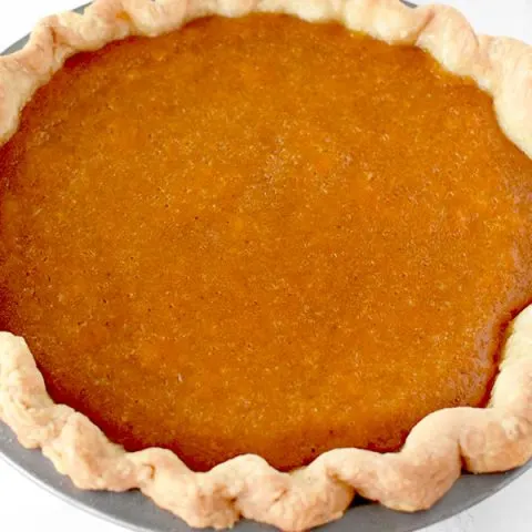 Dairy Free sweet potato pie in a homemade pie crust on a marble counter