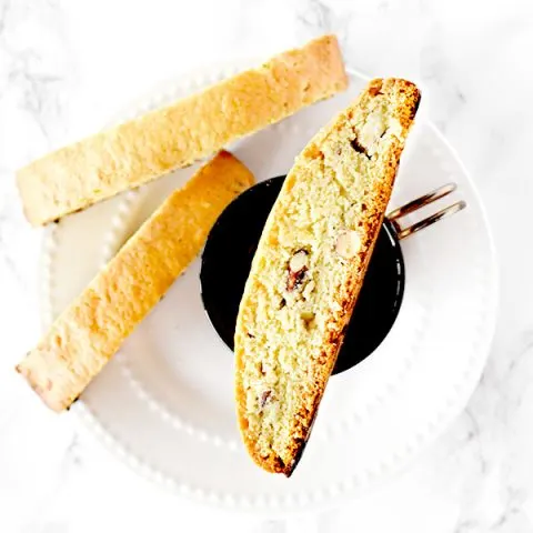 mandel bread with almonds on a plate and coffee cup