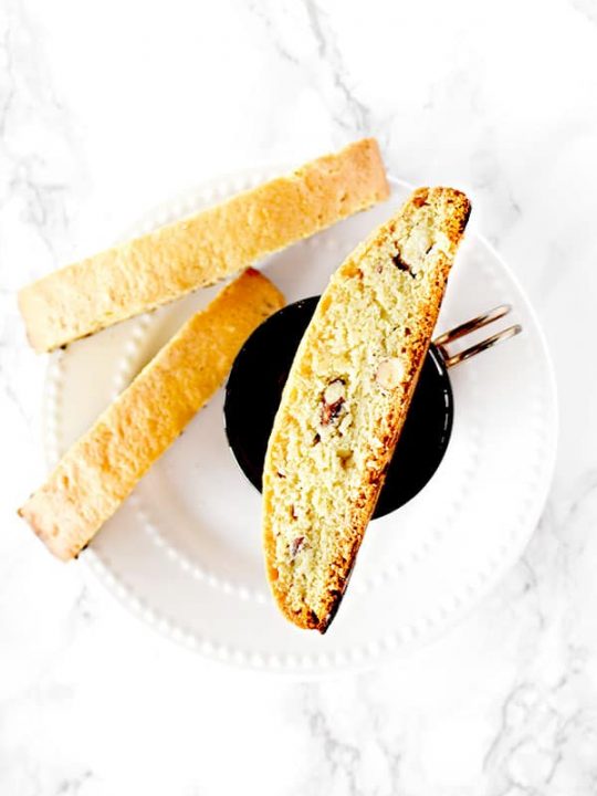 mandel bread with almonds on a plate and coffee cup