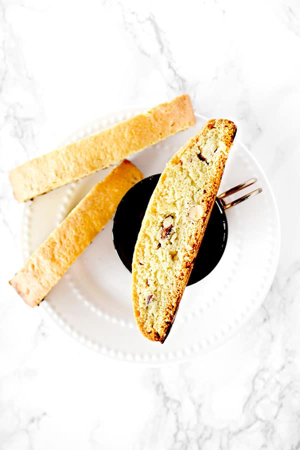 mandel bread with almonds on a plate and coffee cup