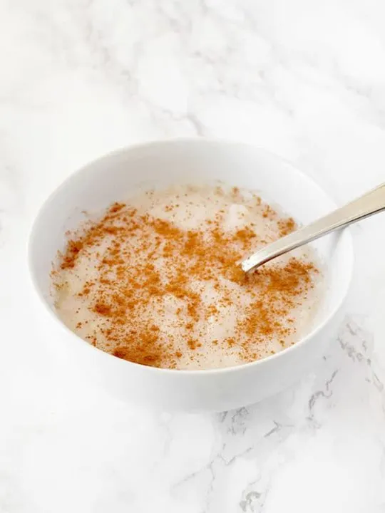 Semolina Porridge sprinkled with cinnamon in a bowl on a counter