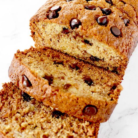 sliced banana chocolate chip bread on a white marble counter