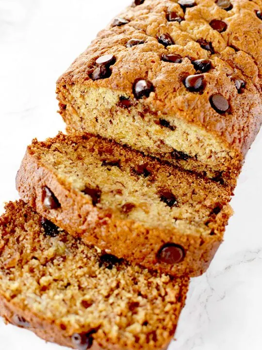 sliced banana chocolate chip bread on a white marble counter