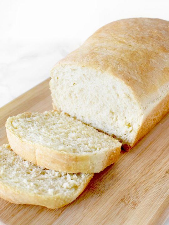 sliced loaf of white bread on a cutting board