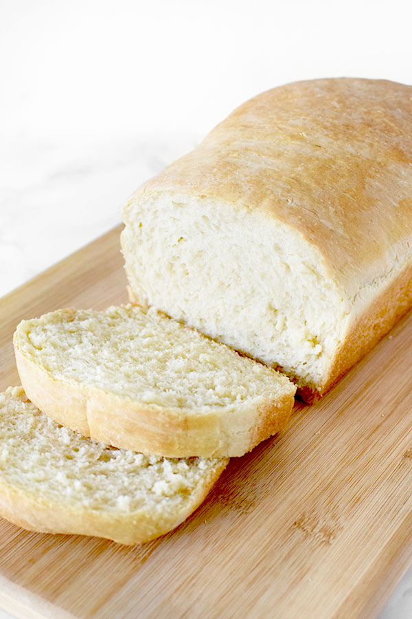 sliced loaf of white bread on a cutting board