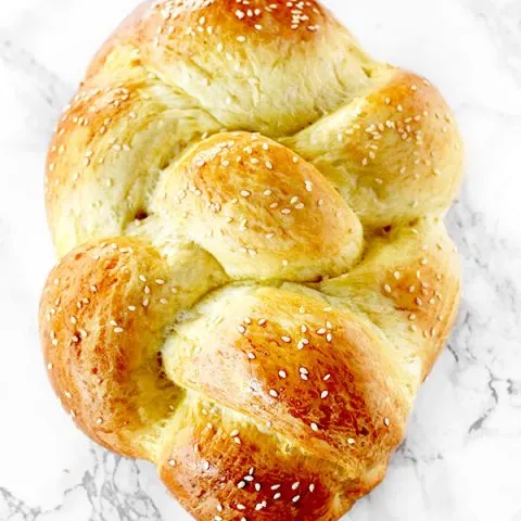 Challah bread on a white marble counter