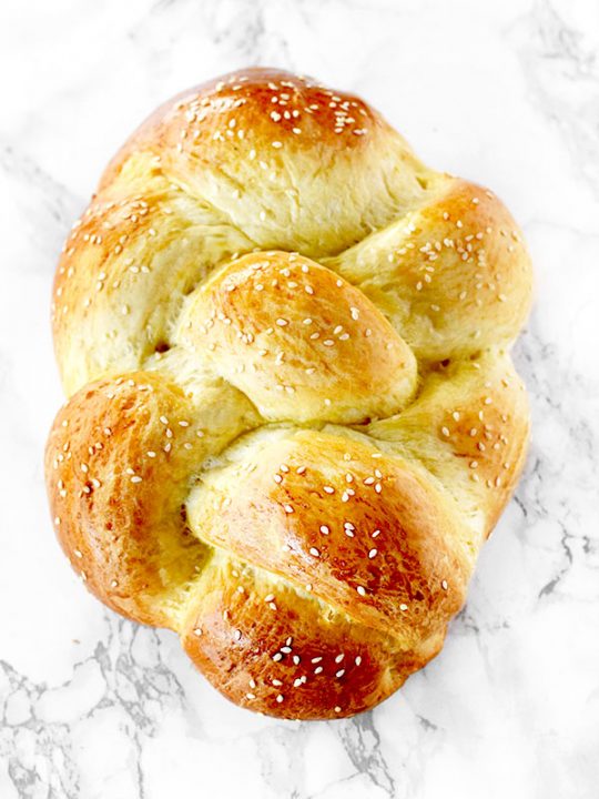 Challah bread on a white marble counter