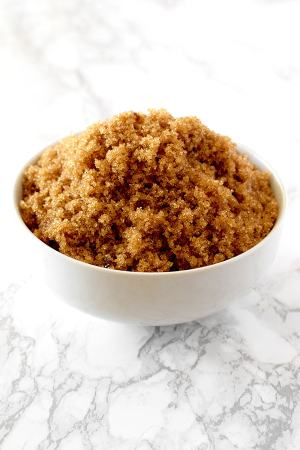 light brown sugar in a white bowl on a white marble counter