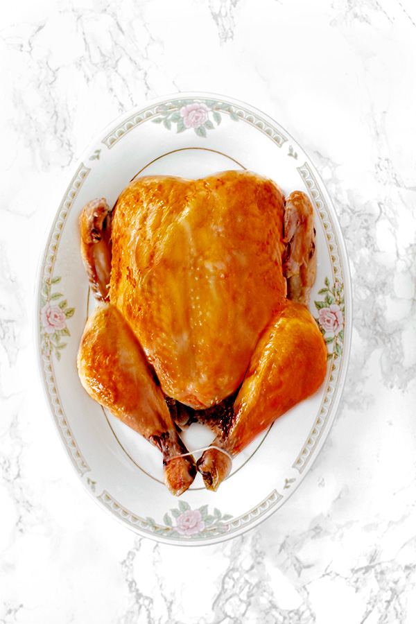 dairy free roasted turkey on platter on a white marble counter