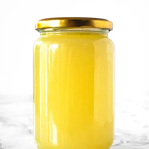 Turkey Stock in a jar on a white marble counter