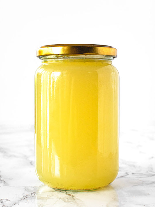 Turkey Stock in a jar on a white marble counter