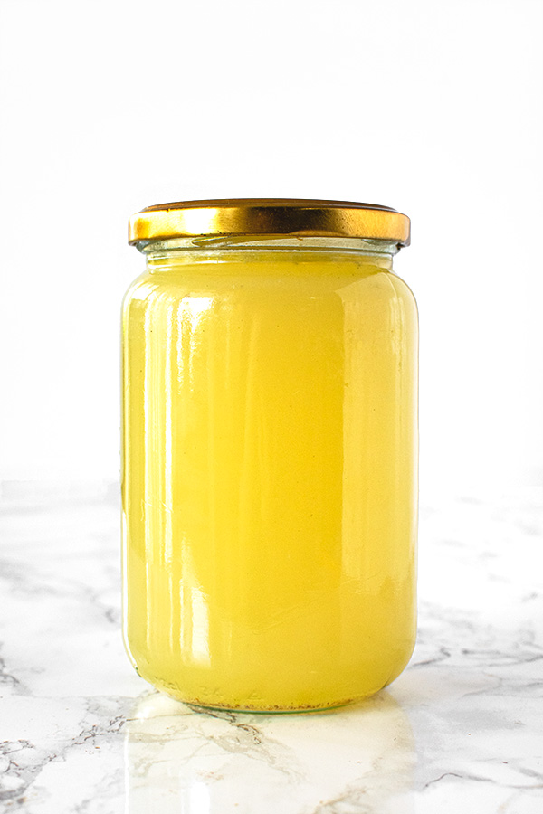 Turkey Stock in a jar on a white marble counter