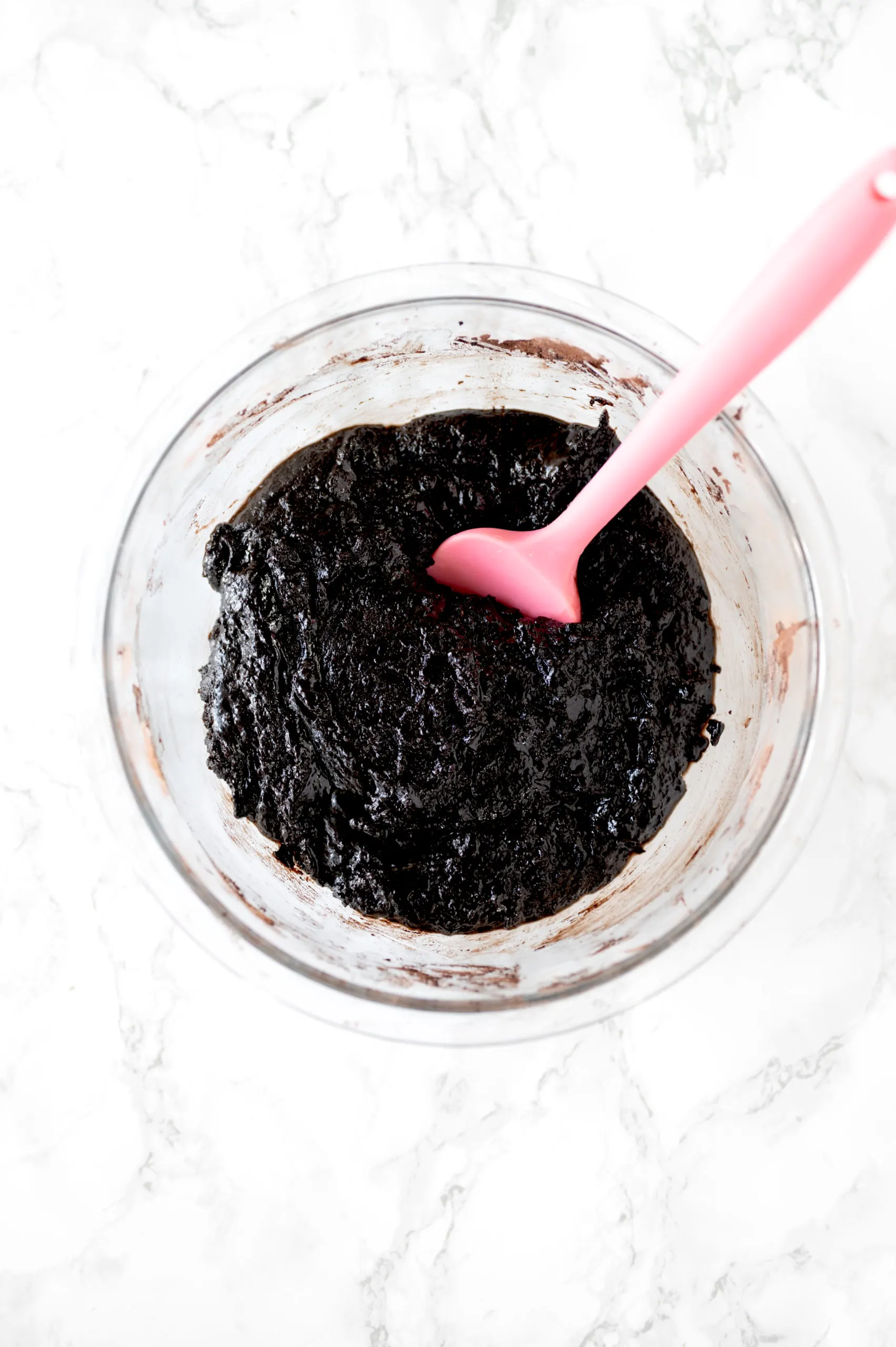 chewy brownies without butter batter in a bowl on a white marble counter