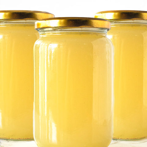 Chicken Wing Broth in jars on a white marble counter