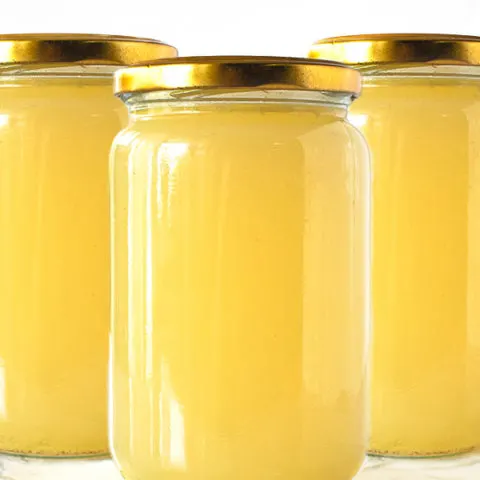 Chicken Wing Broth in jars on a white marble counter