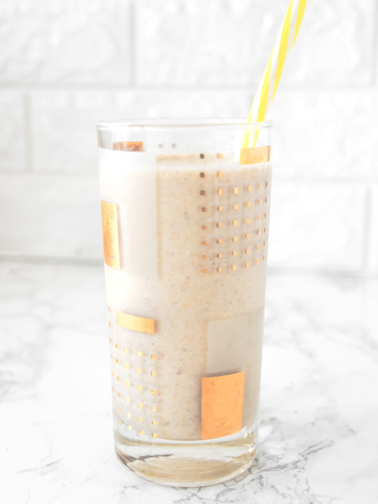 Banana Smoothie without Milk in a glass on a white counter with a yellow straw