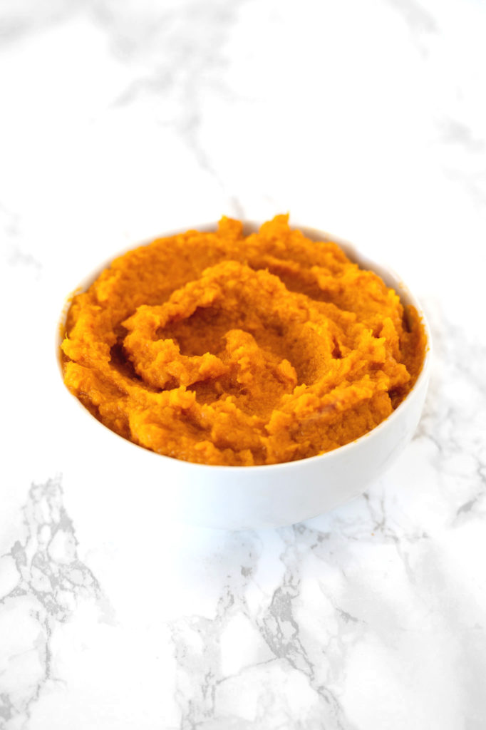 Mashed Sweet Potatoes in a white bowl on a white counter