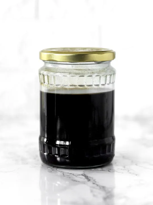 Cold brew coffee in a glass jar on a white marble counter
