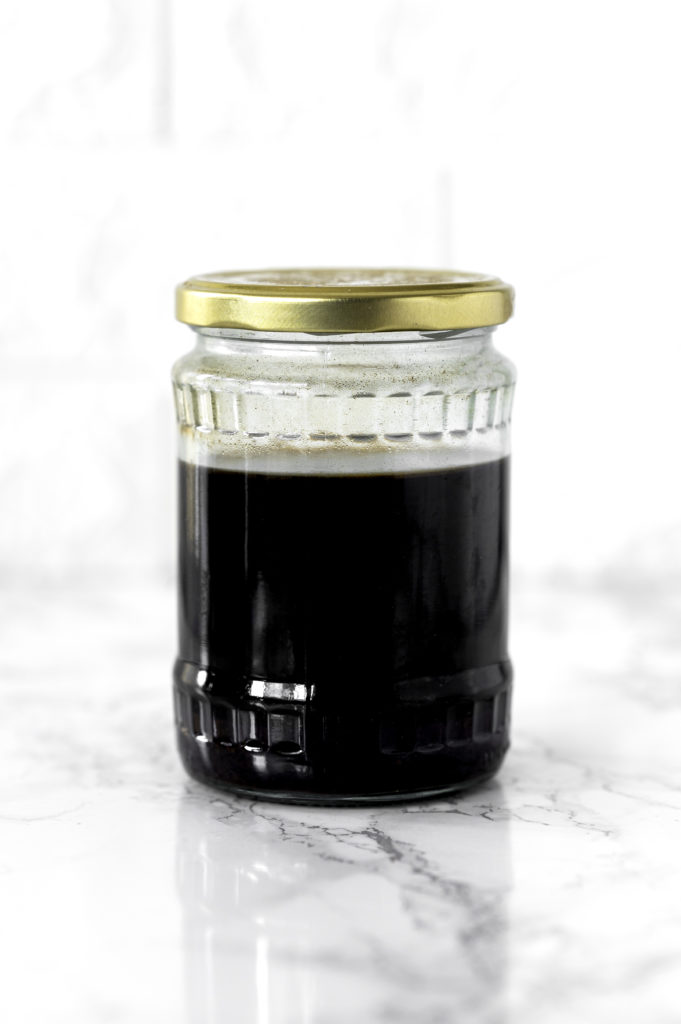 Cold brew coffee in a glass jar on a white marble counter