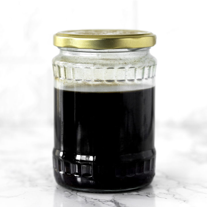 Cold brew coffee in a glass jar on a white marble counter