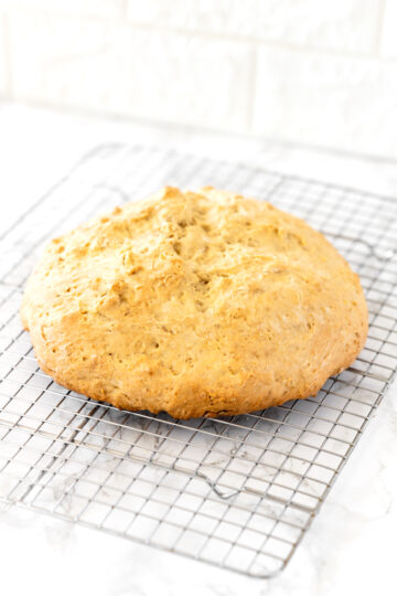 loaf of Irish soda bread on a cooling wrack