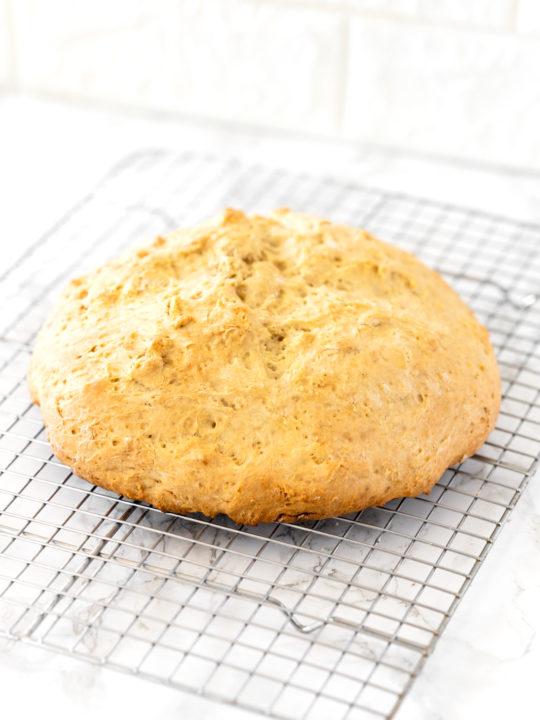 loaf of Irish soda bread on a cooling wrack
