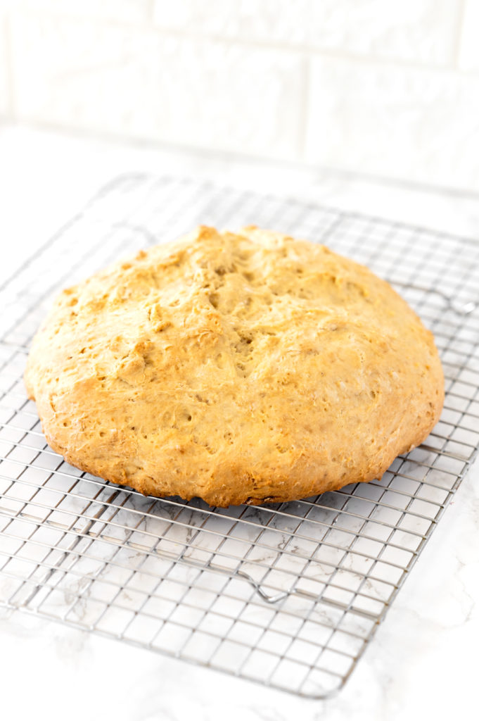 loaf of Irish soda bread on a cooling wrack