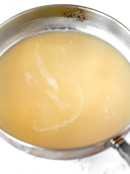 Roux with oil in pan on white marble counter