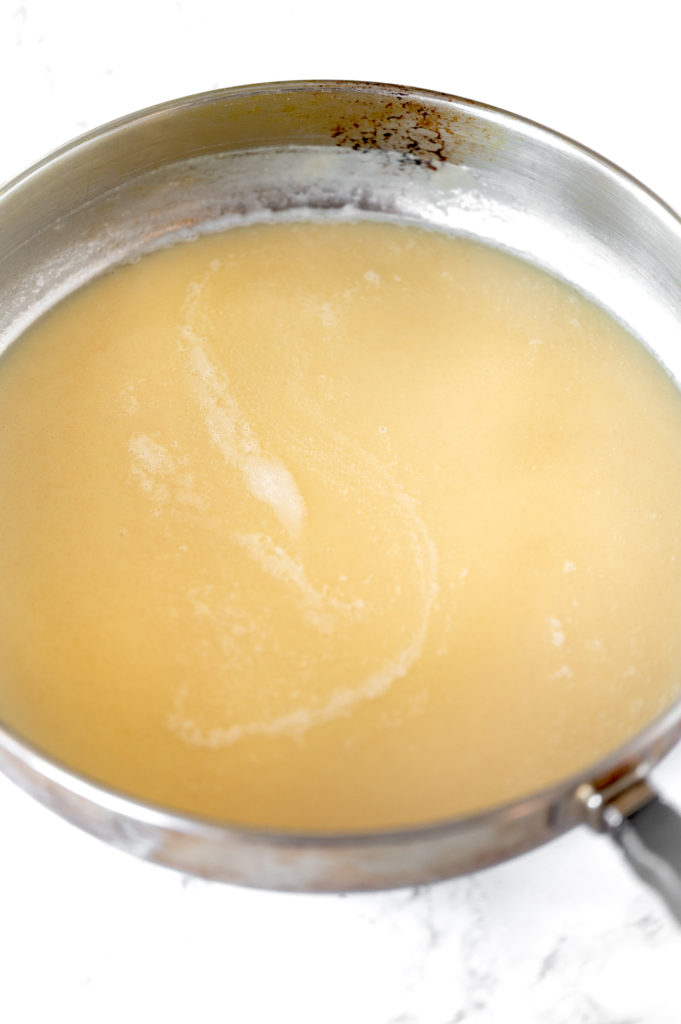 Roux with oil in pan on white marble counter