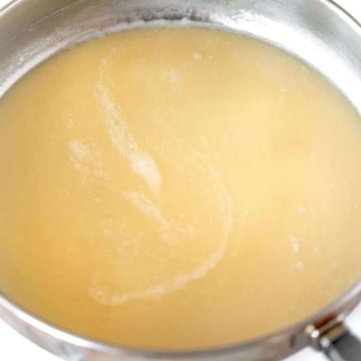 Roux with oil in pan on white marble counter