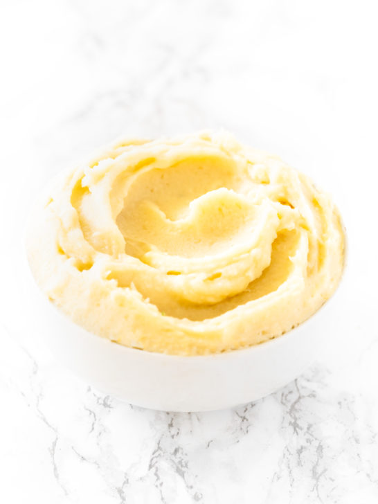 Instant Mashed Potatoes in a white bowl on a white marble counter