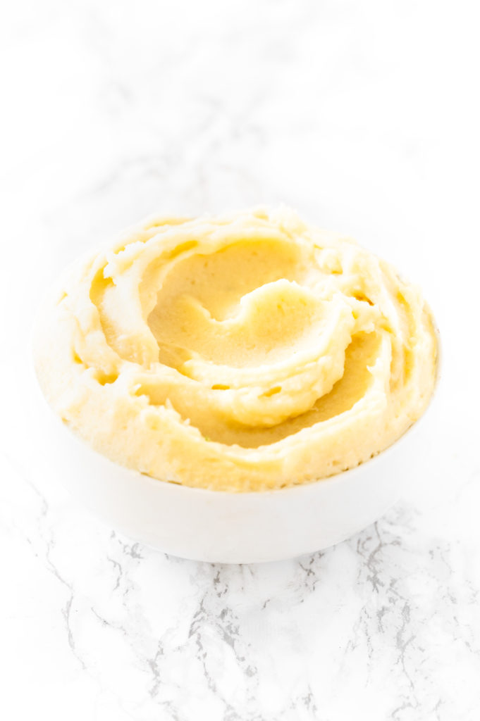 Instant Mashed Potatoes in a white bowl on a white marble counter