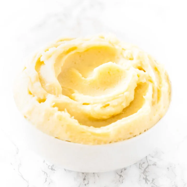 Instant Mashed Potatoes in a white bowl on a white marble counter