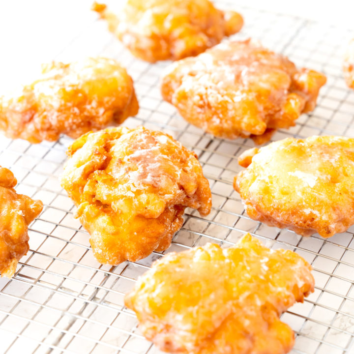 Dairy free apple fritters on a cooling wrack