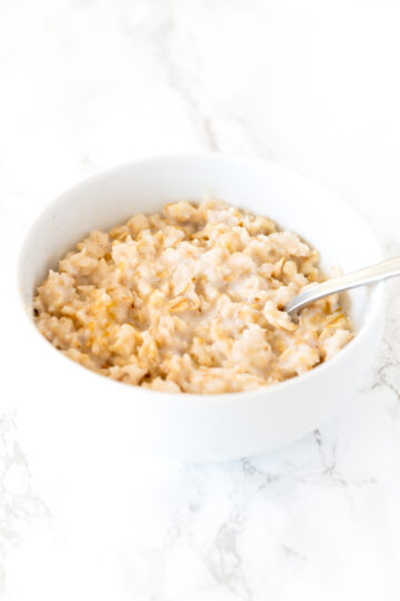 oatmeal in a white bowl on a white marble counter