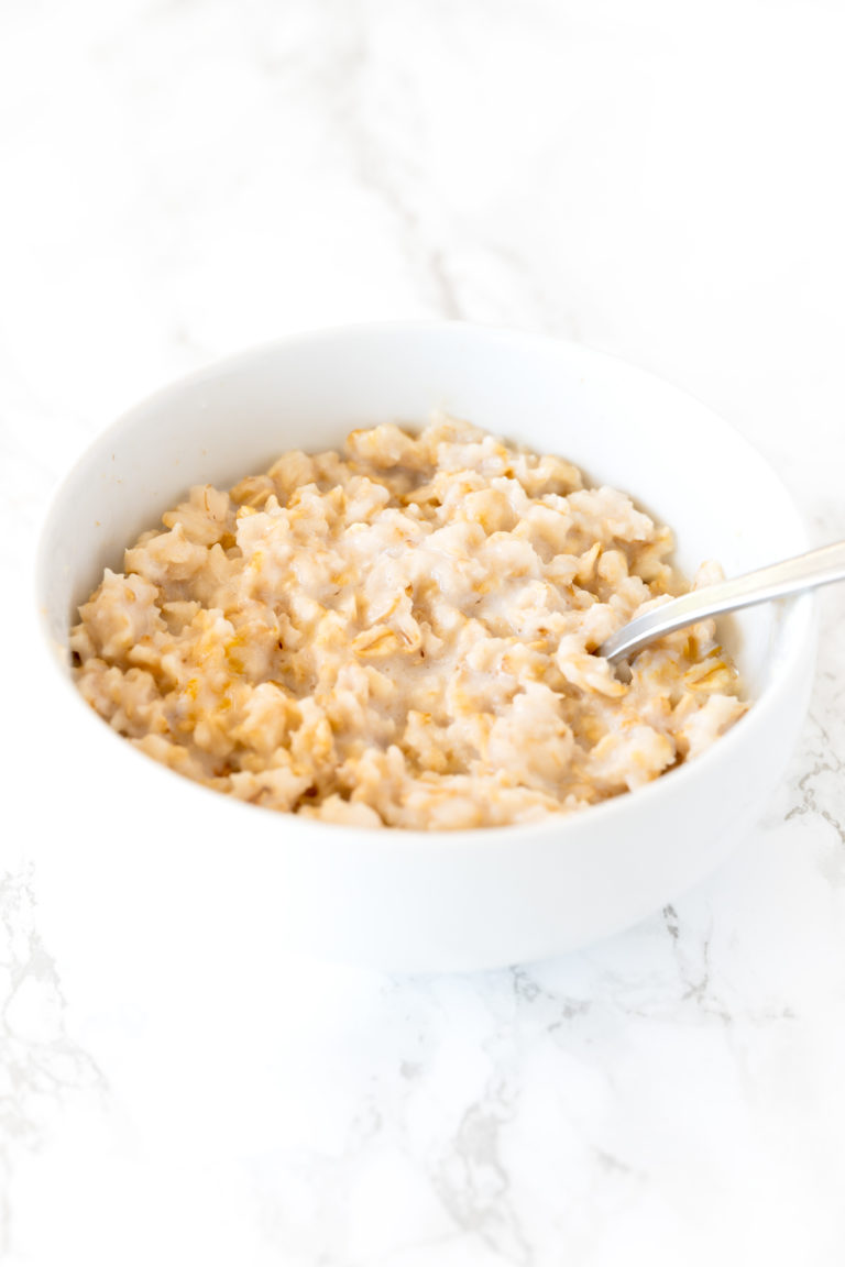 oatmeal in a white bowl on a white marble counter