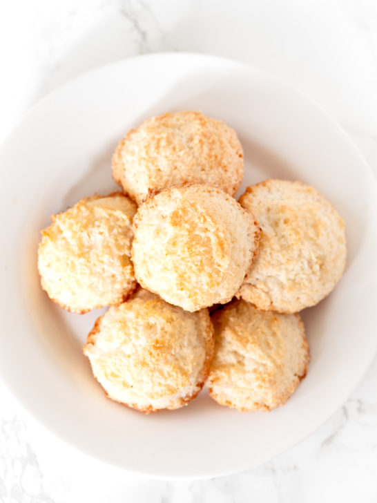 coconut macaroons on a white plate on a white marble counter